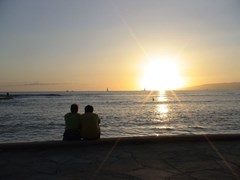 ハワイの夕日を見るカップル
